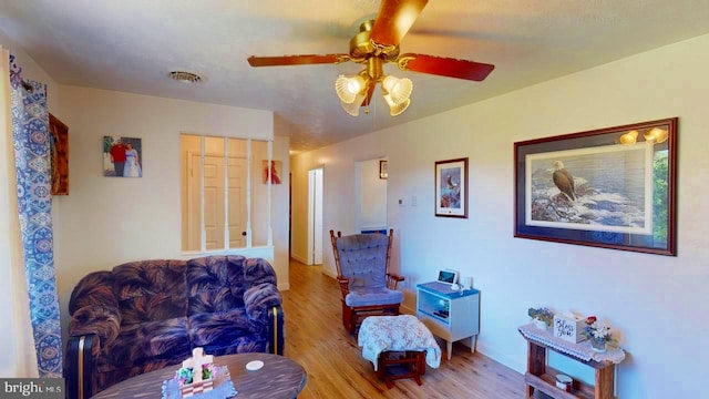 living area featuring ceiling fan and light wood-type flooring