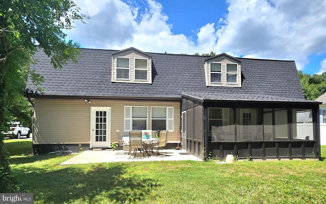 rear view of property featuring a patio area, a sunroom, and a yard