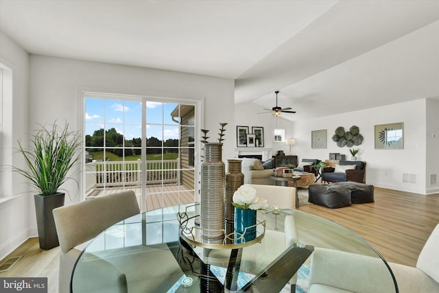 dining area with ceiling fan, light hardwood / wood-style floors, and lofted ceiling