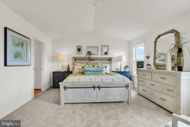 bedroom featuring light colored carpet and vaulted ceiling