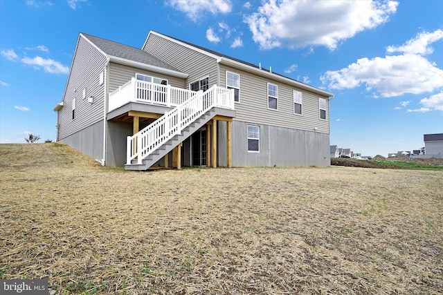 rear view of house featuring a deck