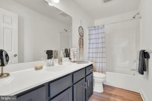 full bathroom with vanity, hardwood / wood-style flooring, toilet, and shower / bath combo with shower curtain