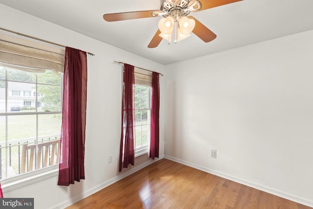 spare room with wood-type flooring and ceiling fan