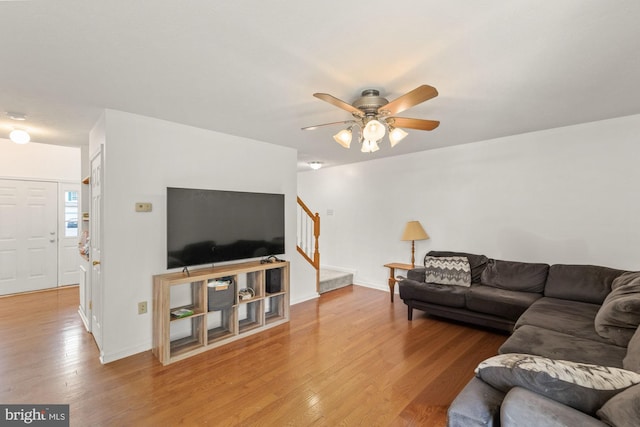 living room with ceiling fan and hardwood / wood-style floors