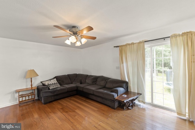 living room with hardwood / wood-style floors, ceiling fan, and a healthy amount of sunlight