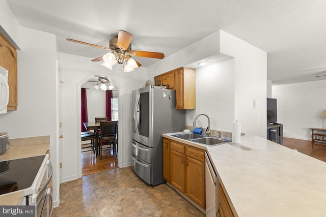 kitchen featuring sink, hardwood / wood-style flooring, ceiling fan, a textured ceiling, and appliances with stainless steel finishes