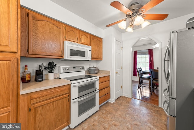 kitchen with white appliances and ceiling fan