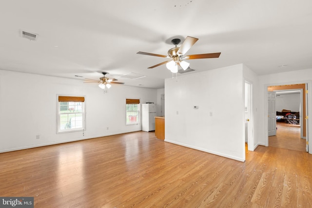 unfurnished living room featuring ceiling fan and light wood-type flooring