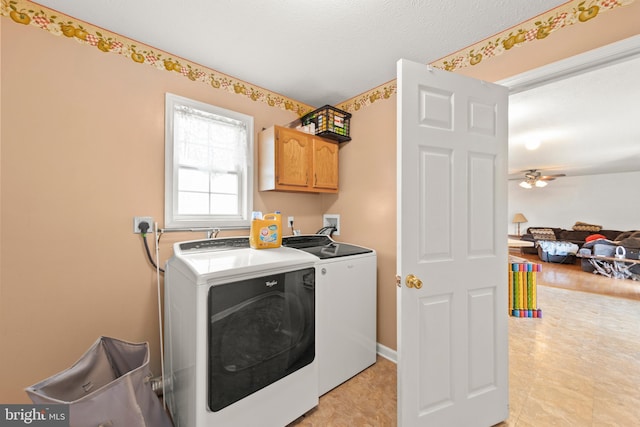 clothes washing area featuring ceiling fan, cabinets, light hardwood / wood-style flooring, and washing machine and clothes dryer