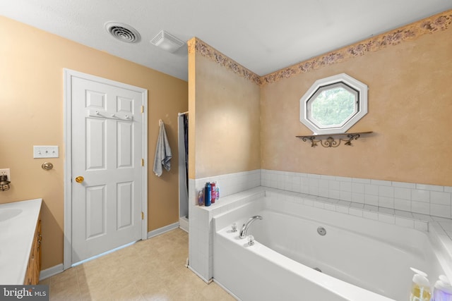 bathroom with vanity and a bathtub