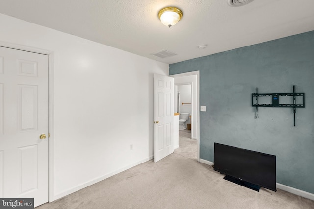 carpeted bedroom featuring a textured ceiling