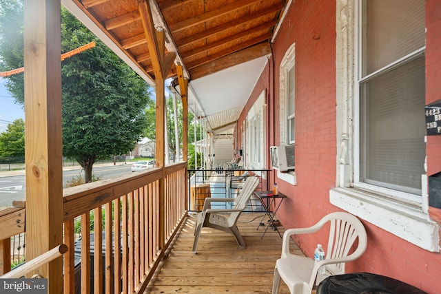 deck with covered porch and cooling unit