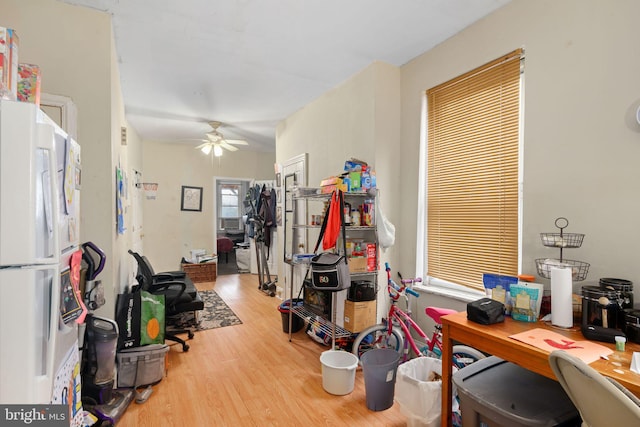 interior space with ceiling fan, cooling unit, and hardwood / wood-style floors