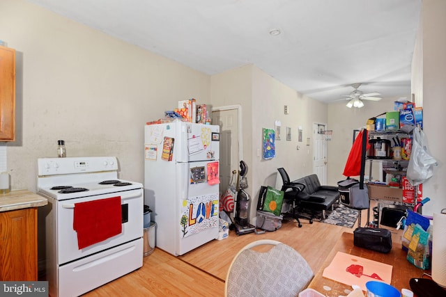 kitchen featuring ceiling fan, white appliances, and light wood-type flooring