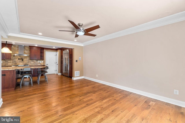 unfurnished living room with dark hardwood / wood-style floors, ceiling fan, and ornamental molding