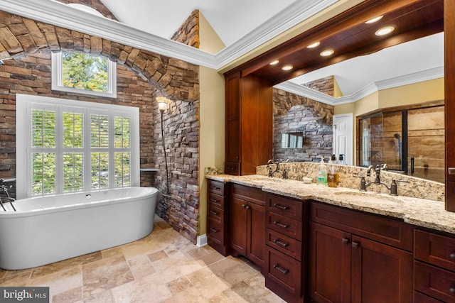 bathroom featuring a washtub, vanity, and crown molding