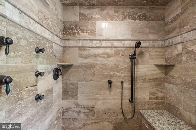 bathroom with tiled shower