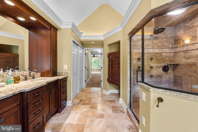 bathroom with vanity, an enclosed shower, and ornamental molding