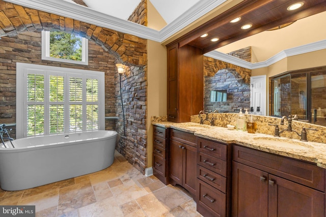 bathroom featuring a towering ceiling, vanity, a bath, and ornamental molding