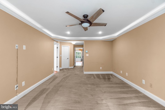 carpeted empty room with ceiling fan and ornamental molding