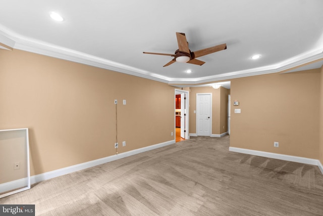 carpeted spare room with ceiling fan and crown molding