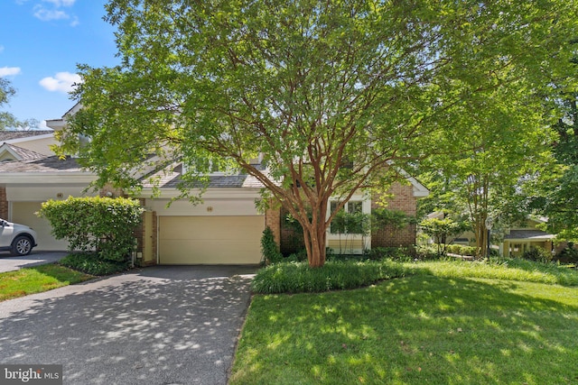 obstructed view of property featuring a front lawn