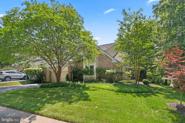 view of property hidden behind natural elements with a front yard