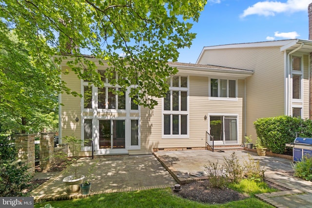 rear view of property featuring a patio area