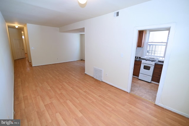 unfurnished living room with light wood-type flooring