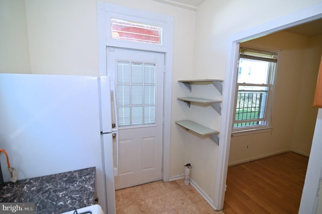 doorway to outside with light wood-type flooring