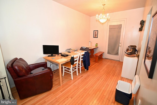 office space with a chandelier and light hardwood / wood-style flooring