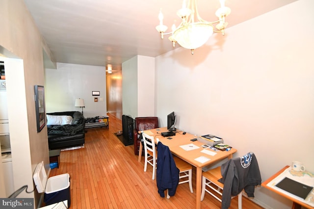 office area with light wood-type flooring and a notable chandelier