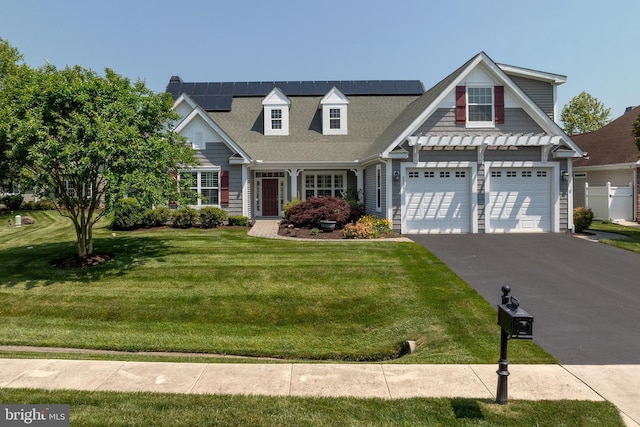 view of front facade featuring solar panels and a front lawn