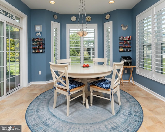 dining space featuring light tile patterned floors and a wealth of natural light