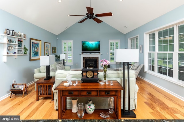 living room with ceiling fan, hardwood / wood-style floors, and lofted ceiling