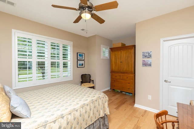 bedroom with ceiling fan and light hardwood / wood-style floors