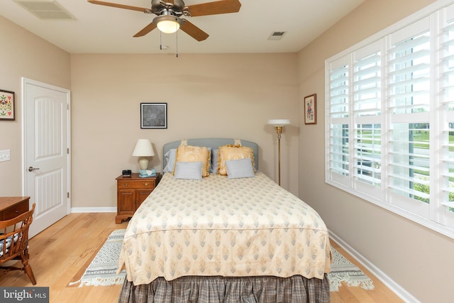 bedroom with light hardwood / wood-style floors and ceiling fan