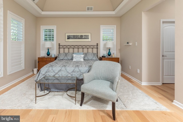 bedroom featuring hardwood / wood-style flooring and multiple windows