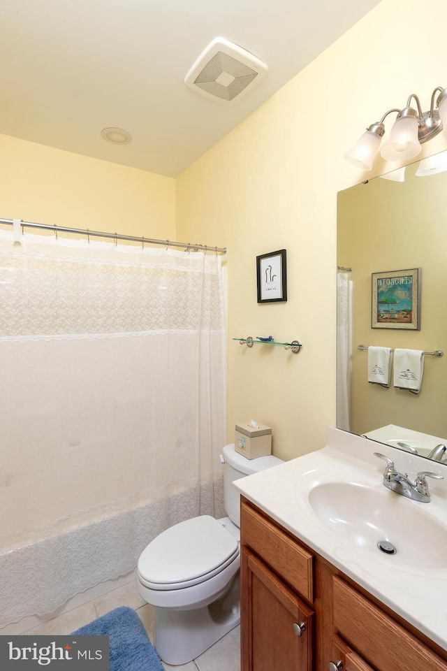 bathroom featuring toilet, vanity, tile patterned floors, and a shower with shower curtain