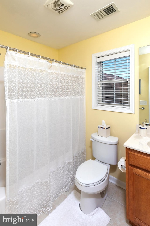 bathroom featuring tile patterned floors, vanity, and toilet