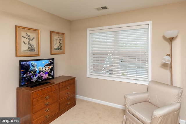 sitting room featuring light carpet