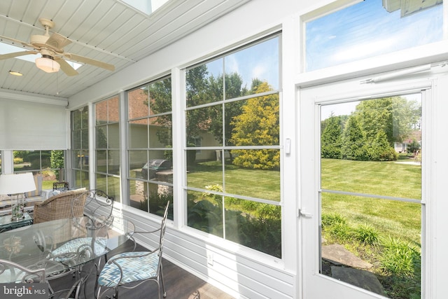 sunroom / solarium featuring ceiling fan and wood ceiling