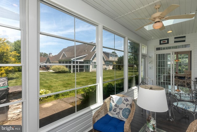 sunroom / solarium featuring ceiling fan