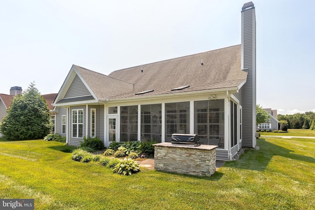 back of house with a sunroom and a yard