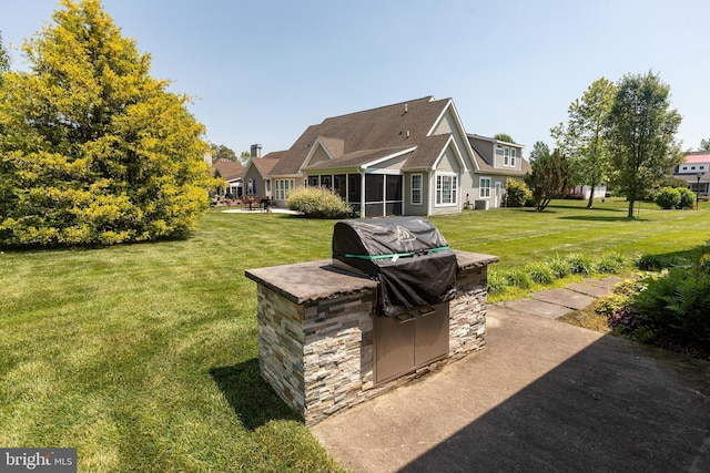 view of yard featuring an outdoor kitchen and a patio