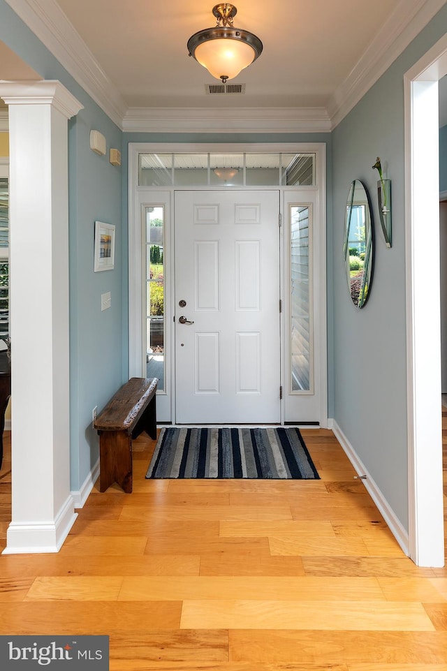 foyer entrance featuring light wood-type flooring and crown molding