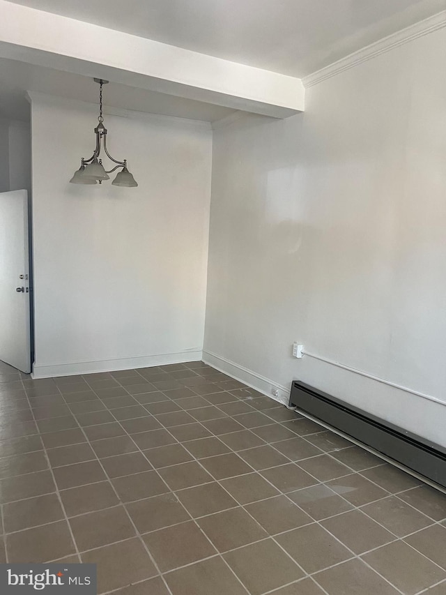 spare room with baseboard heating, ornamental molding, beam ceiling, and dark tile patterned floors