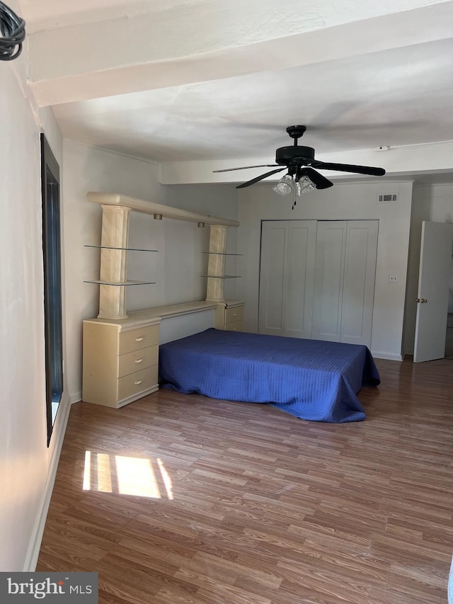 unfurnished bedroom with ceiling fan and hardwood / wood-style floors