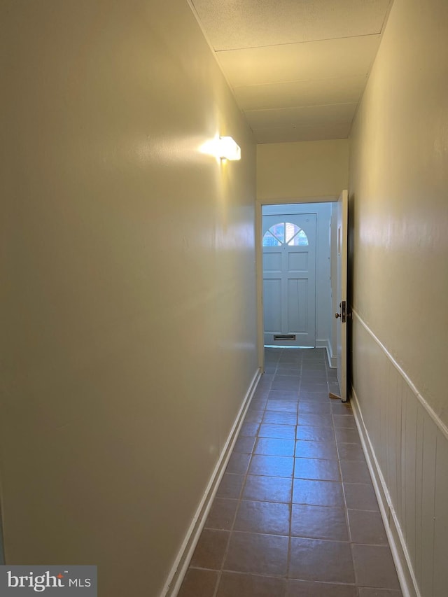 doorway to outside featuring dark tile patterned flooring