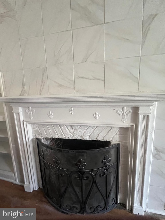 interior details with wood-type flooring and a premium fireplace